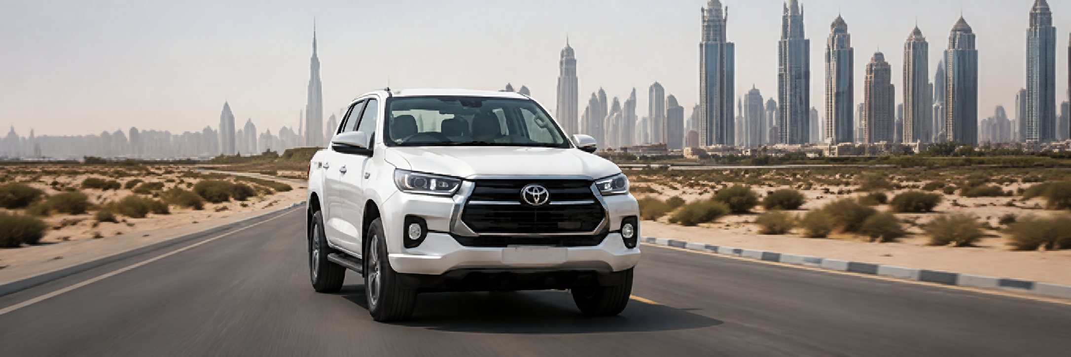Pickup truck driving towards the Dubai skyline